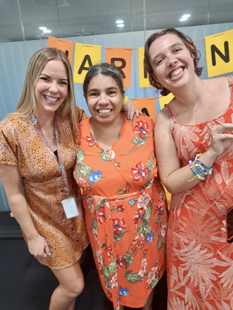 Harmony Day, 3 ladies in orange dresses